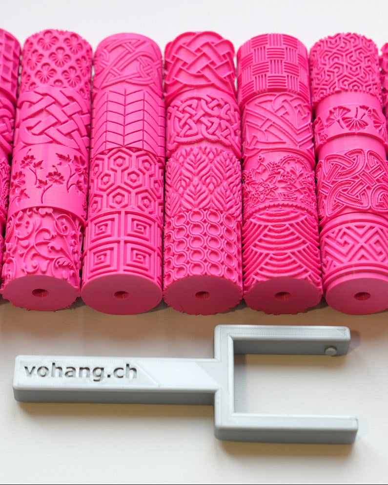 Texture roller for pottery with handle on a white surface, showing pattern detail