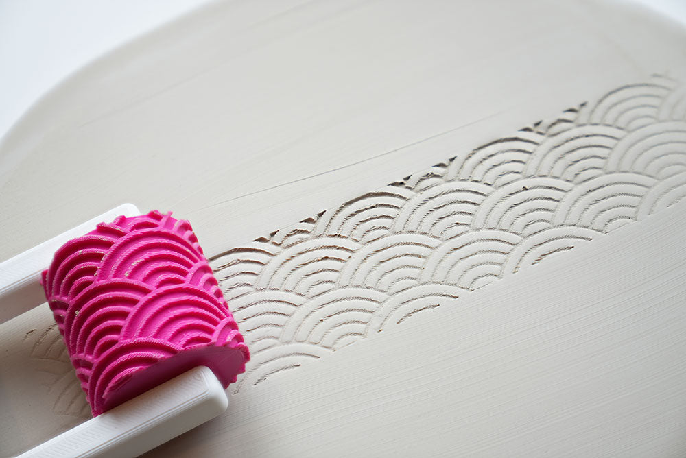 Close-up of the roller head with raised pattern, ready for ceramics
