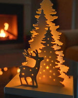 Christmas decoration with deer and tree design, tealight holder slot visible from the back