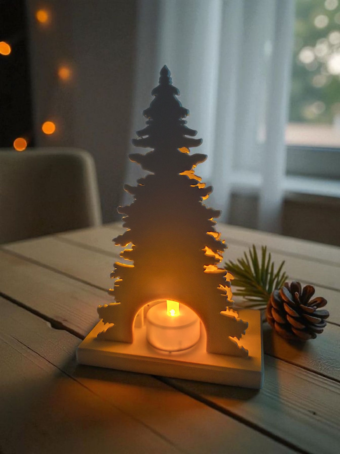 Christmas decoration with deer and tree design, tealight holder slot visible from the back