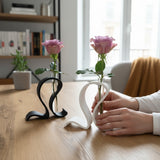 Minimalist test tube vase with single green stem in Scandinavian interior