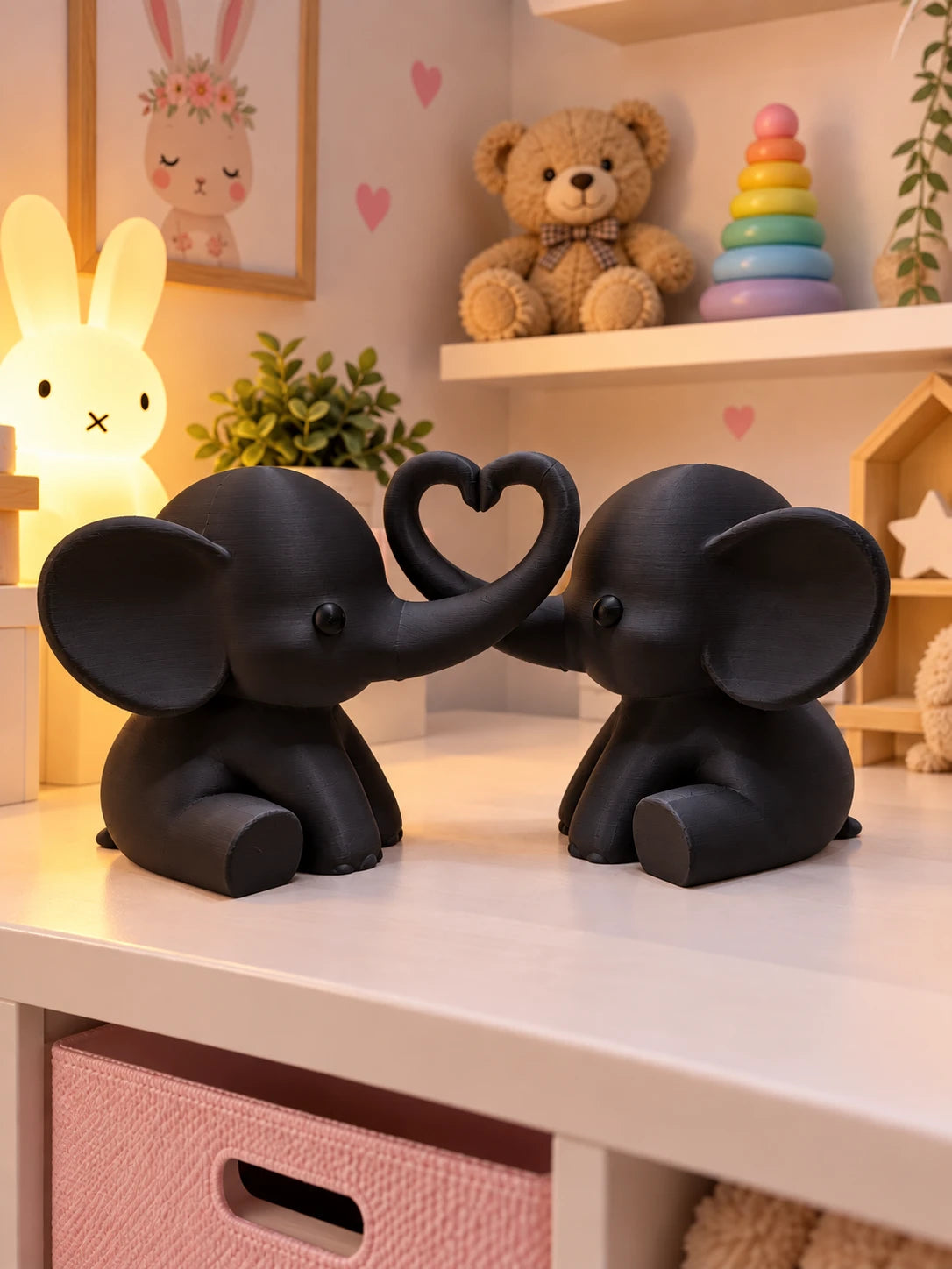Black elephant pair with trunks forming a heart on a shelf
