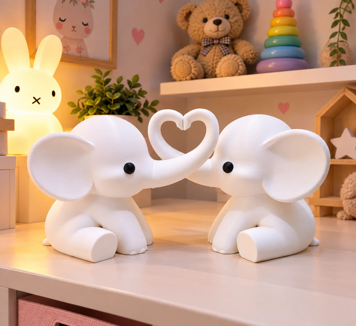 White pair of elephants with trunks forming a heart in a nursery