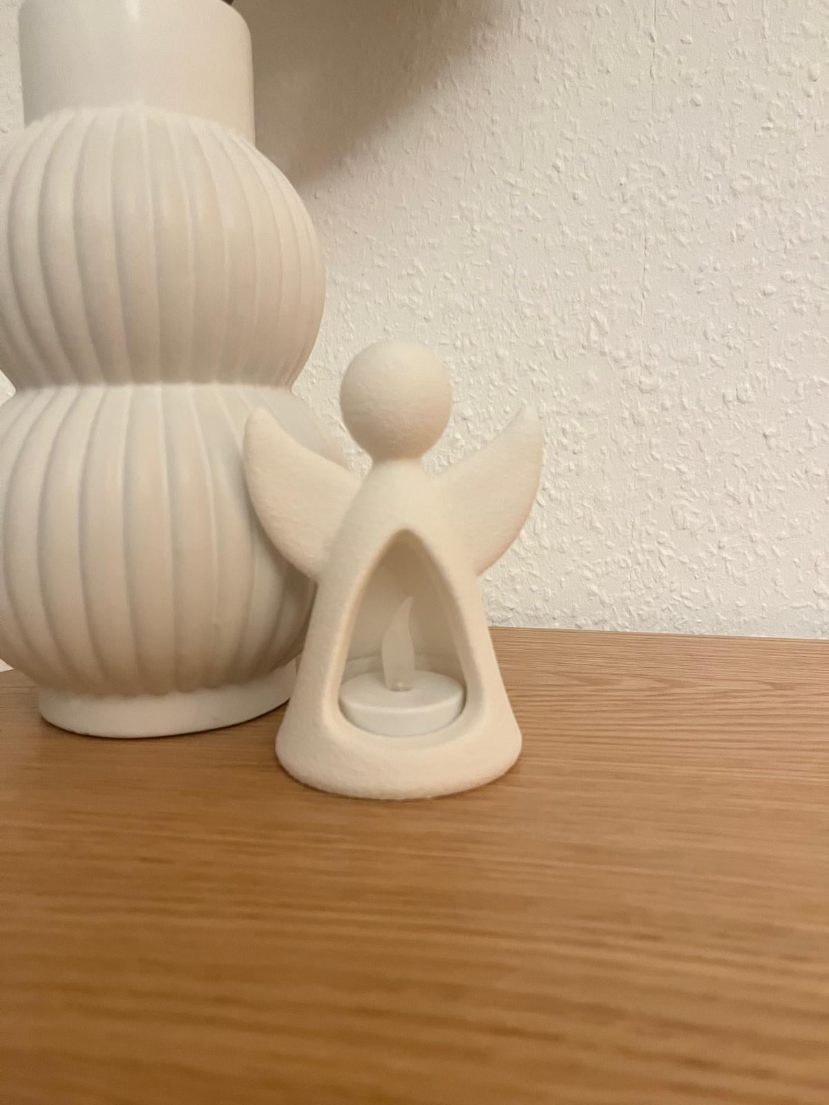 Angel figure with LED tealight glowing from inside