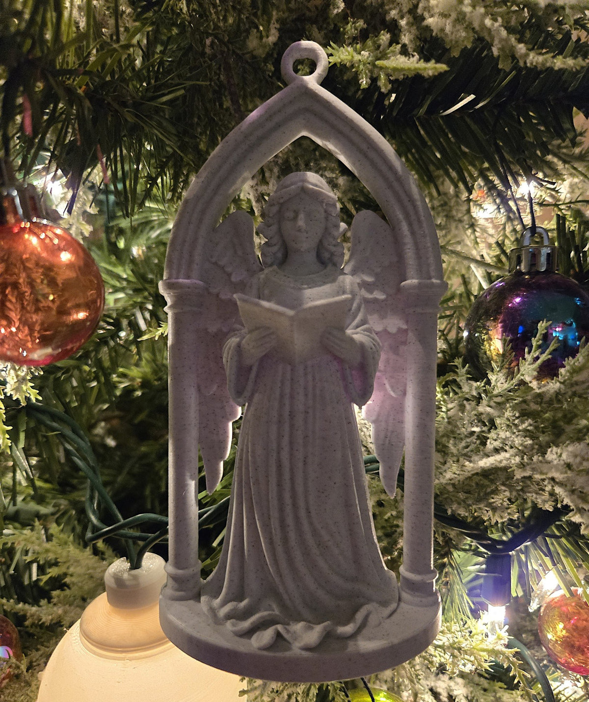 Victorian angel in a Gothic archway as a Christmas tree ornament