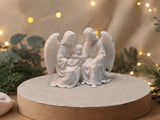 Mary and Joseph with the Child, enfolded by angel wings