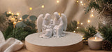 Mary and Joseph with the Child, enfolded by angel wings