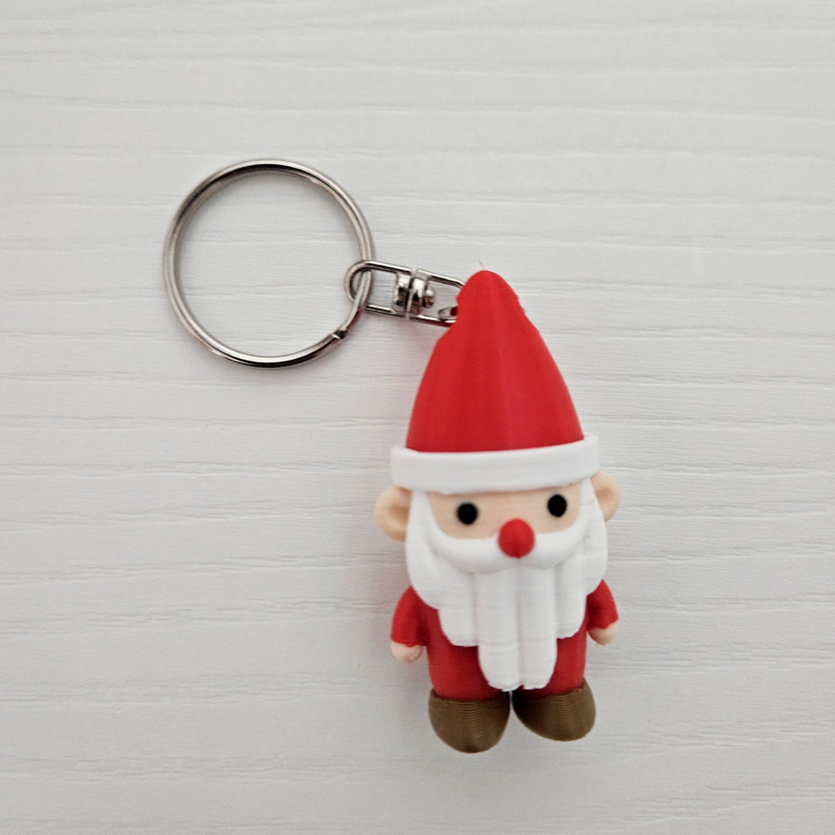 Cute Santa Claus keychain charm with a hole in the hat