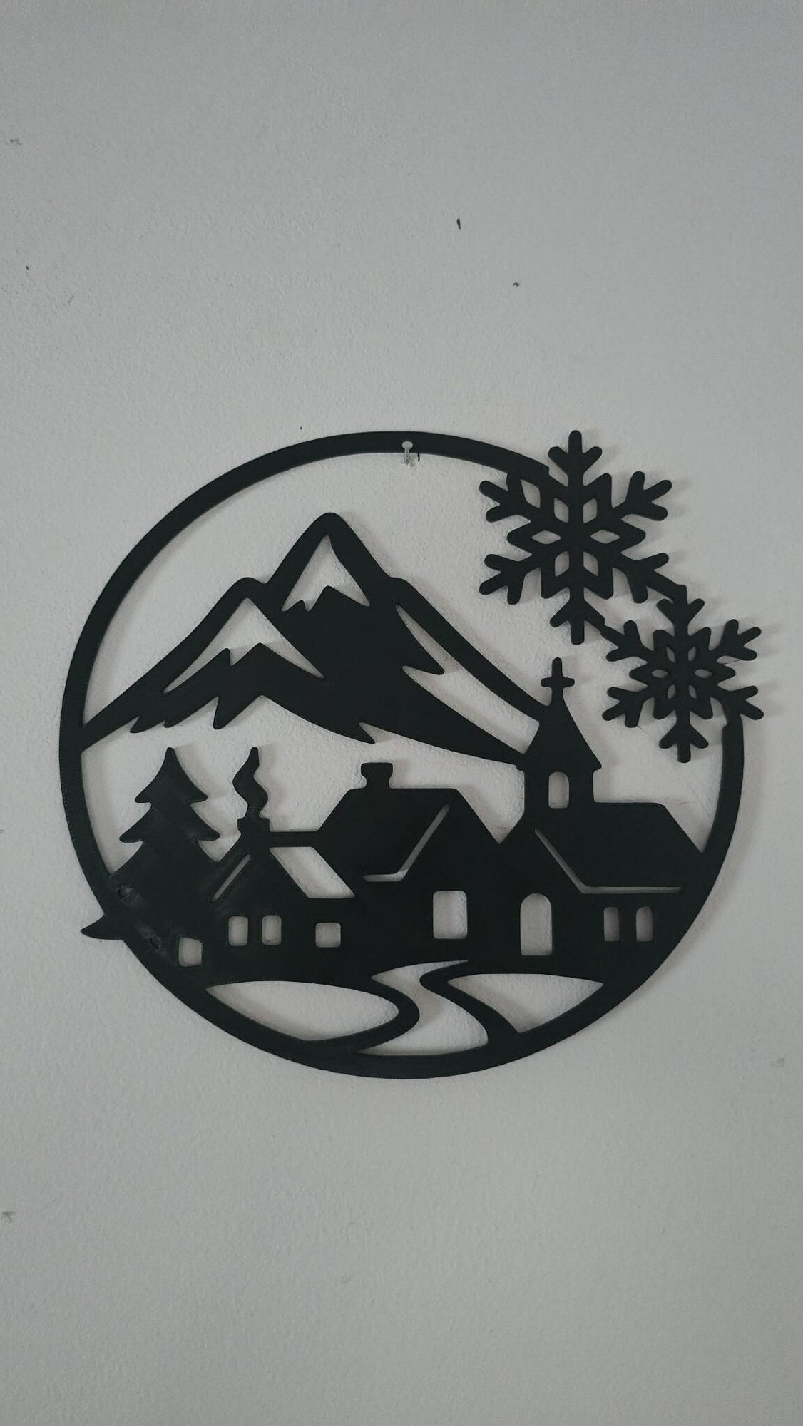 Silhouette of a winter village with a church, houses and fir trees