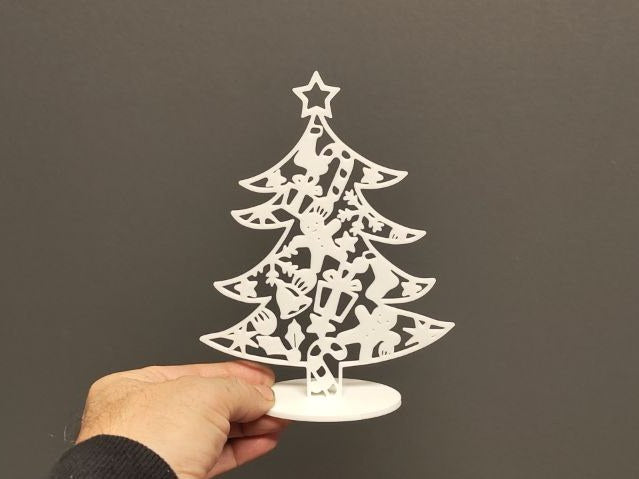 Small free-standing Christmas tree with baubles
