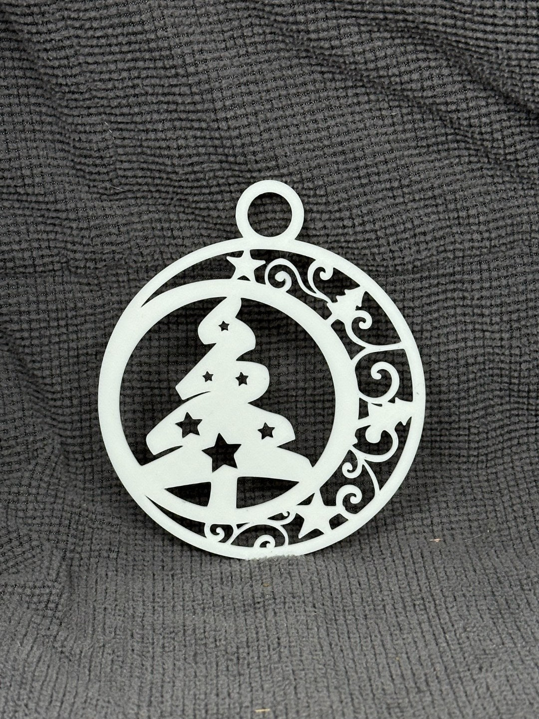 Round Christmas tree ornament with a Christmas tree and stars