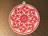 Round Christmas tree ornament with candy canes forming a snowflake