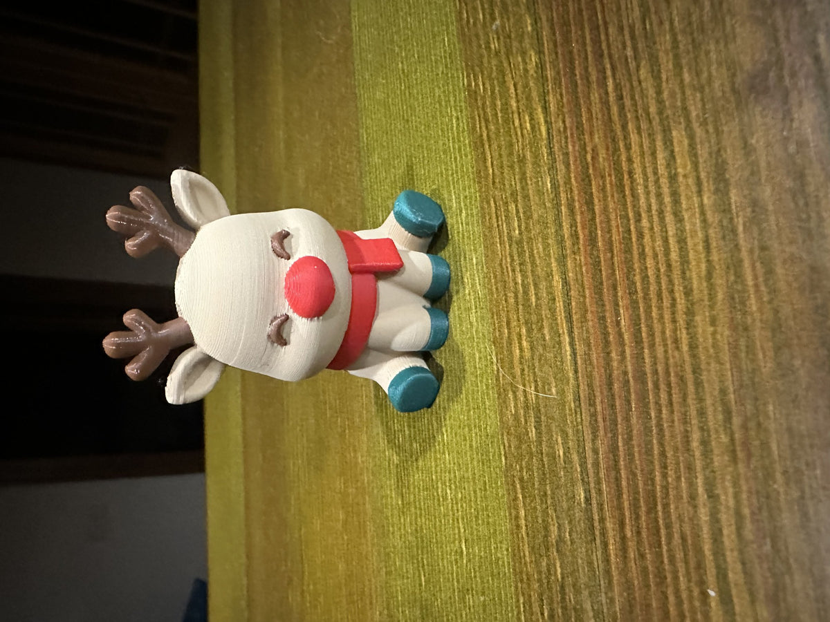 Cute reindeer with a red nose and scarf