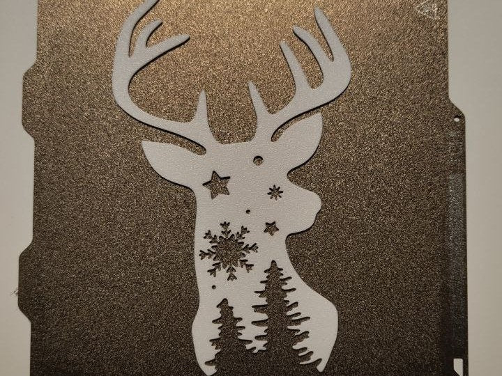 Reindeer silhouette with stars and Christmas trees