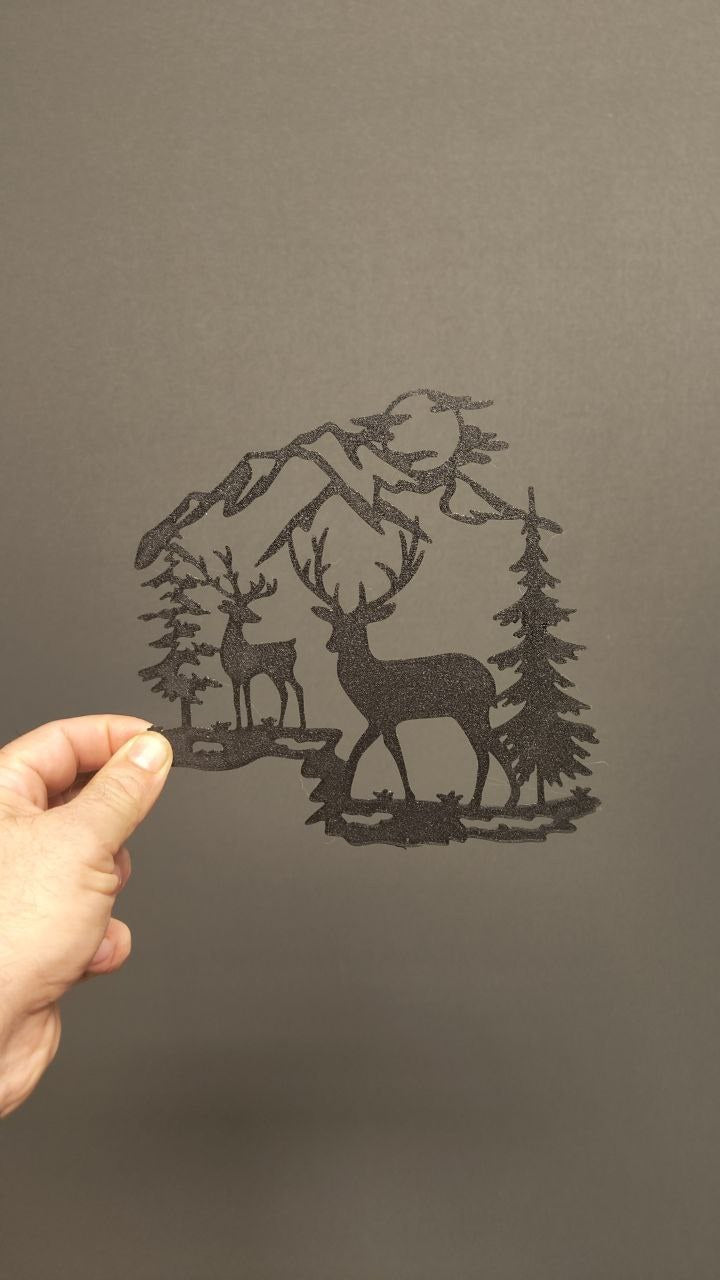 Wall decoration with a reindeer in front of mountains