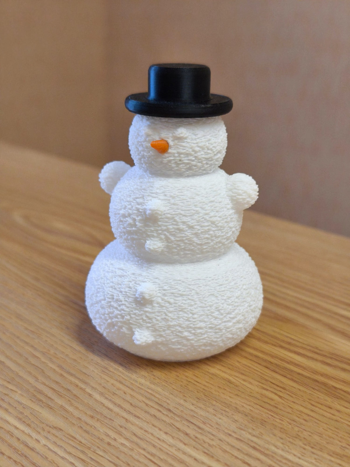 Snowman with hat and nose over an LED tealight