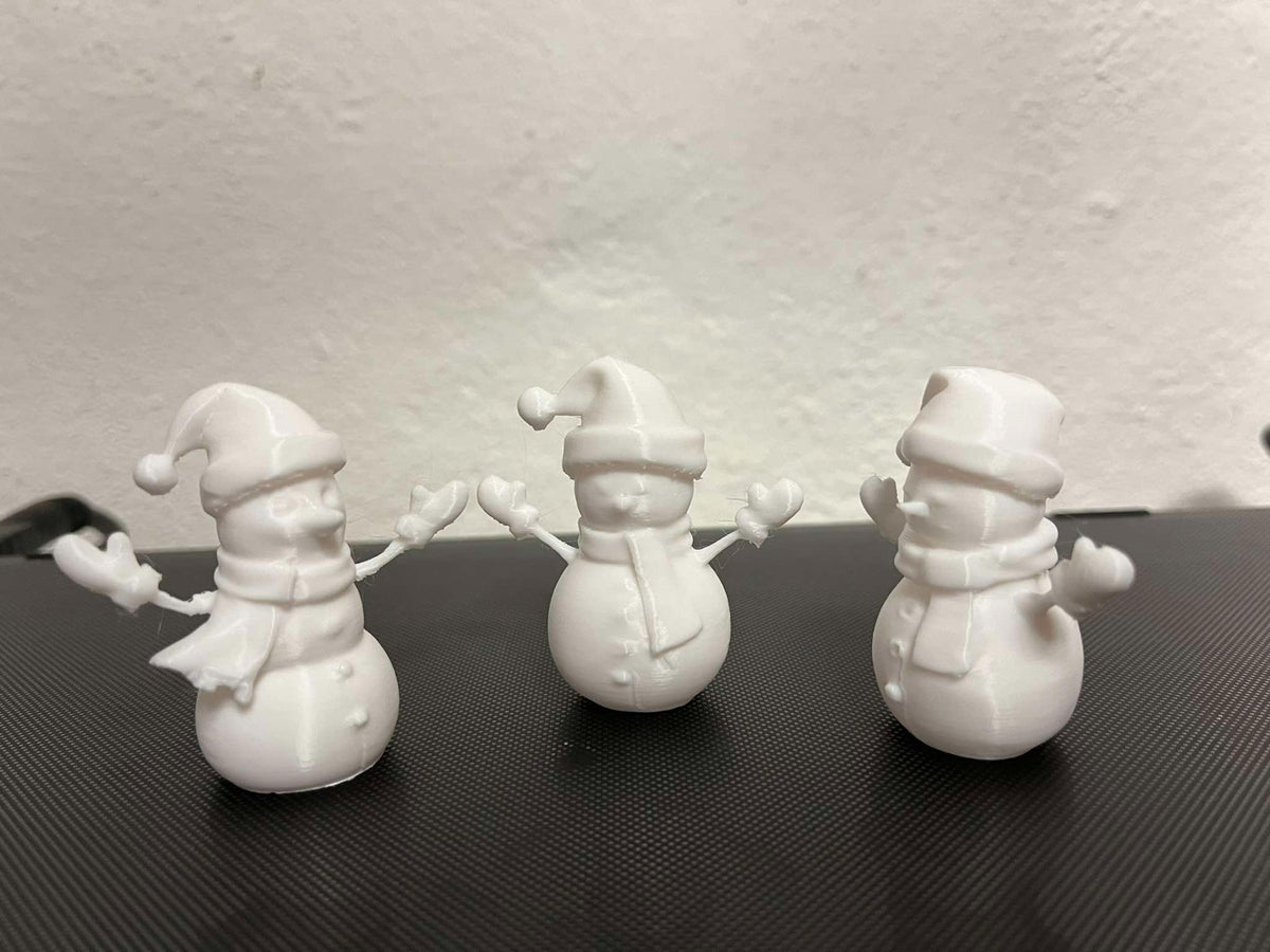 Snowman figure with scarf, mittens and hat