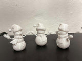 Snowman figure with scarf, mittens and hat