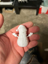 Snowman figure with scarf, mittens and hat