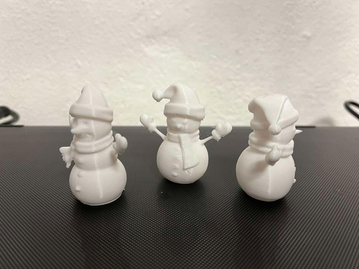 Snowman figure with scarf, mittens and hat